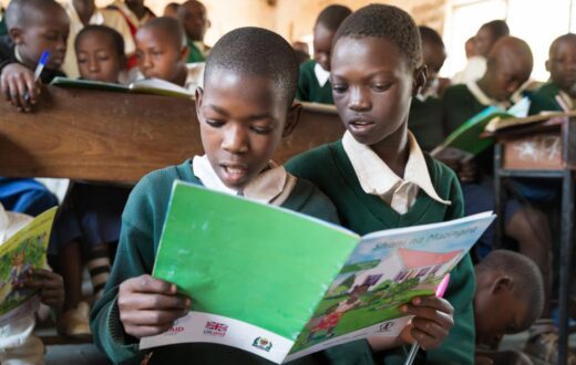 Image of Tanzanian public school pupils reading a book