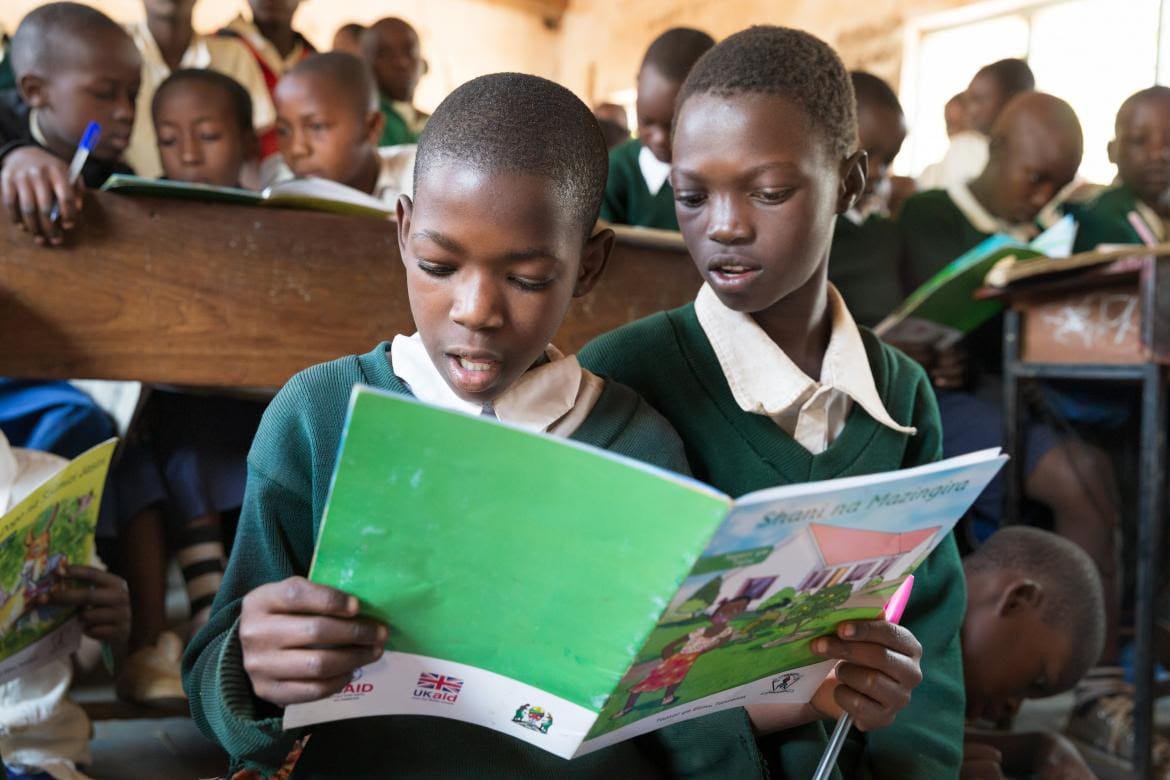 Image of Tanzanian public school pupils reading a book